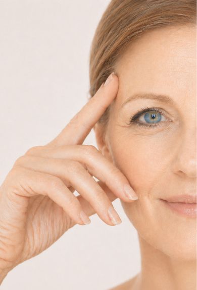 Woman indicating laxity along her jawline